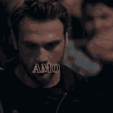 a close up of a man 's face with the word amo above it