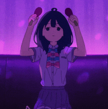 a girl in a bow tie is holding a pair of maracas in her hands