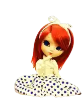 a doll with red hair and blue eyes is wearing a polka dot dress