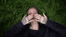 a woman is making a funny face with her hands in the air .