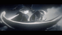 a person is sitting in a boat in a dark room .