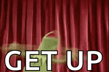 kermit the frog is standing in front of a red curtain with the words get up written in white letters .