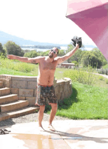 a man without a shirt is standing with his arms outstretched