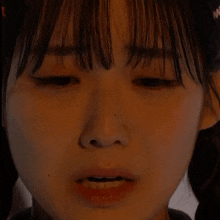 a close up of a girl 's face with her eyes closed and pigtails
