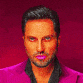 a man with a beard wearing a bow tie and a red jacket
