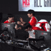 a group of people are sitting in front of a screen that says ' hg global ' on it