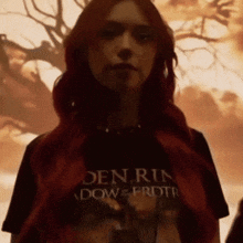 a woman with red hair is wearing a den run t-shirt