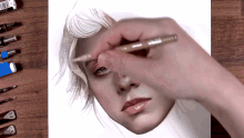 a person is drawing a woman 's face with a pencil that has the number 10 on it