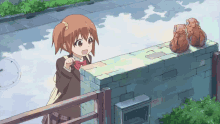 a girl is standing next to a brick wall