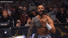 a man in a wrestling ring holds a sign that says ' i love you '