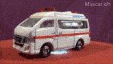 a toy ambulance with the word ambulance on the side of it