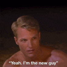 a shirtless man says " yeah i 'm the new guy " in a dark room