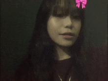 a woman with a pink bow on her head