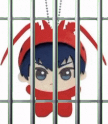 a stuffed toy is behind bars in a prison cell .