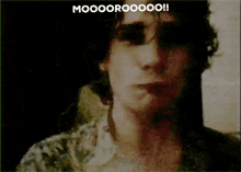 a close up of a man 's face with a caption that says mooooroooo