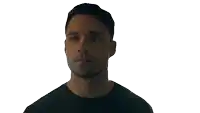 a man in a black shirt is looking at the camera with his eyes closed