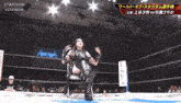 a woman is sitting in a chair in a wrestling ring with a sign that says stardom on it
