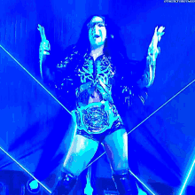 a female wrestler in a blue light with the next thing written on the bottom of the image
