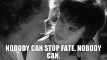 a man and a woman are kissing in a black and white photo with a quote that says nobody can stop fate .