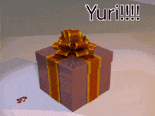 a gift box with a bow and the word yuri written on the bottom