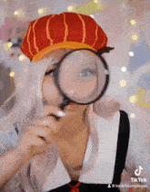 a woman looking through a magnifying glass with a tiktok watermark on the bottom