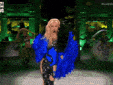 a woman in a blue and black outfit is dancing on a stage with #ladygo written on the bottom right