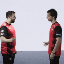 two men are standing next to each other and one has a shirt that says dreammode on the sleeve