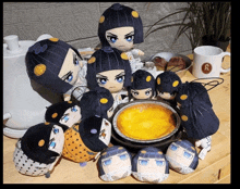 a bunch of stuffed cartoon characters are sitting around a pot of food