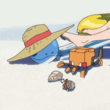 a blue whale wearing a straw hat is laying on the beach next to a crab