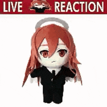 a stuffed toy of a girl in a suit and tie with red hair .