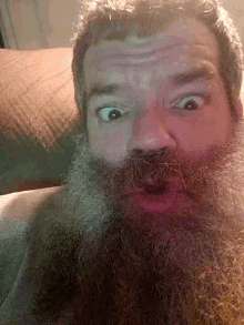 a man with a beard has a red spot on his forehead