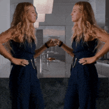 two women in blue jumpsuits are toasting each other