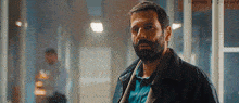 a man with a beard is standing in a hallway with the words haynah e discord on the bottom