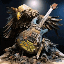 a statue of an eagle and a guitar with the words the strong family on it