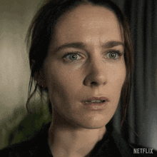a close up of a woman 's face with a netflix logo on the bottom