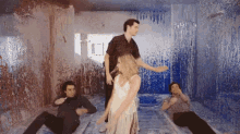 a group of people dancing in a room covered in paint