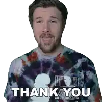 a man wearing a tie dye shirt says " thank you "