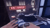 a person is holding a cigarette and a cat is laying on a table .