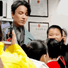 a man is taking a picture of a girl with his cell phone