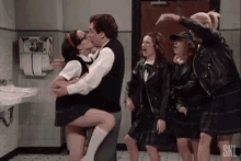 a man and woman are kissing in a bathroom with snl written on the bottom