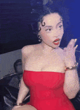 a woman in a red dress with a cross on her necklace