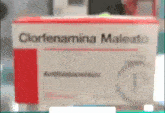 a box of clorfenamina maleato sits on a shelf in a pharmacy .