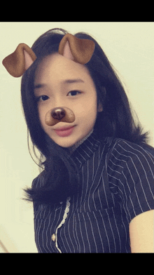 a girl wearing a striped shirt and a dog mask