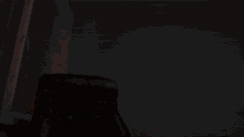 a black leather chair is sitting in front of a window in a room