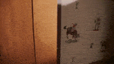 a wall with a cowboy on a horse and a cactus