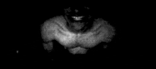 a black and white photo of a man without a shirt .