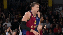 a basketball player with the number 6 on his jersey looks surprised