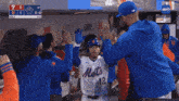 a mets player is surrounded by other players