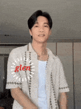 a young man wearing a white shirt with glen written on it