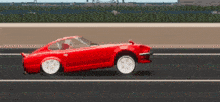 a red car is driving down a road in a pixel art video game
